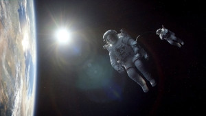 Astronauts George Clooney and Sandra Bullock floating in space in the film, Gravity.
